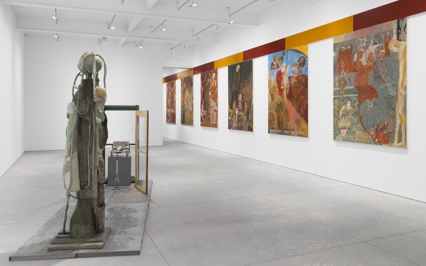 Contemporary mixed-media sculpture and narrative paintings displayed in a white-walled gallery at Art Basel Miami Beach.